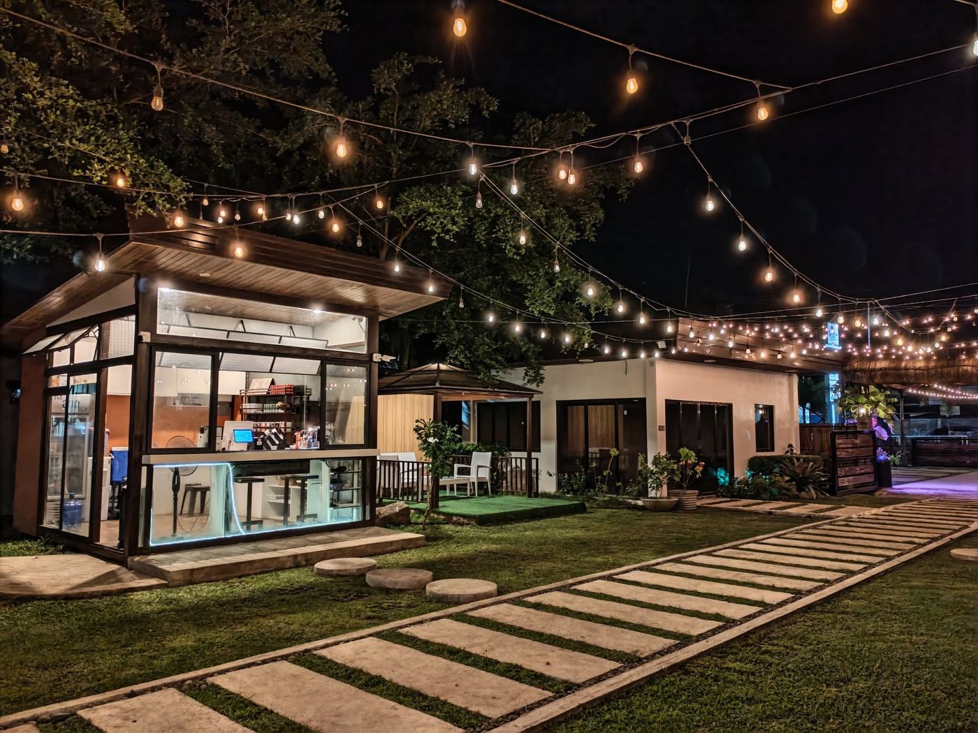 The coffee corner at David's Grill lit up at night