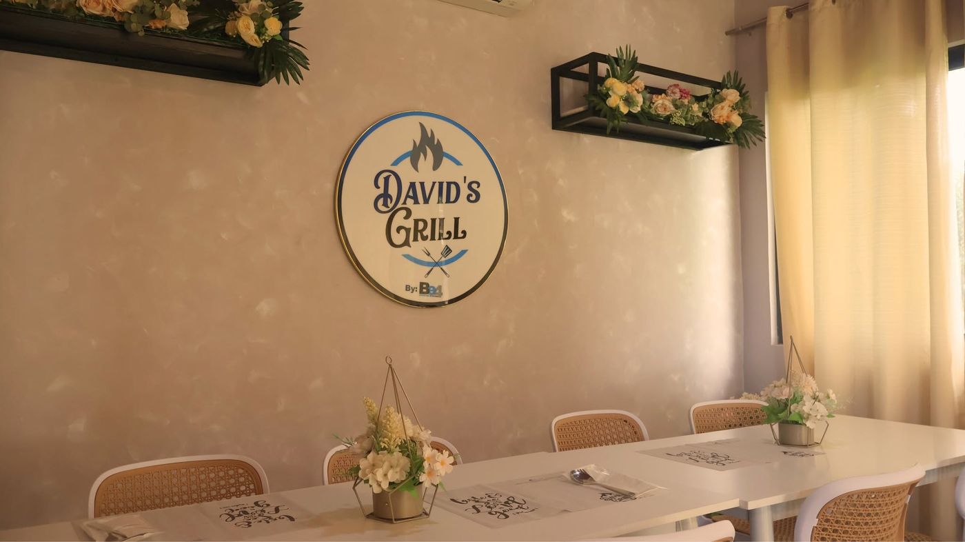 David's Grill dining room with its logo sign on the wall