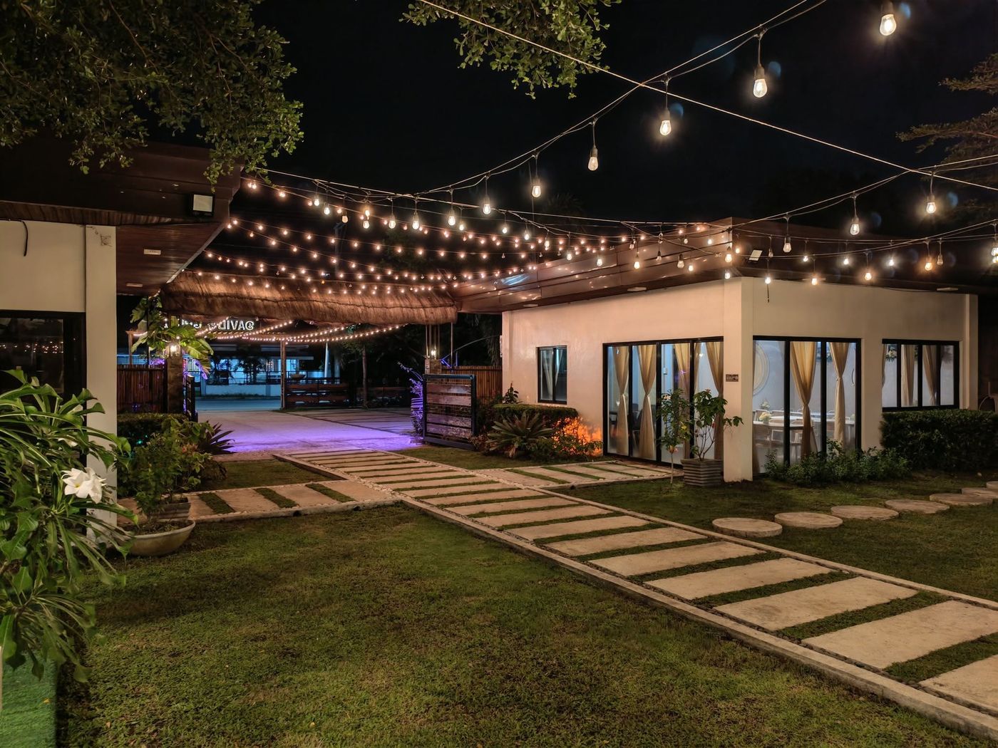 David's Grill dining hall and garden walkway under string lights, ready for an evening event